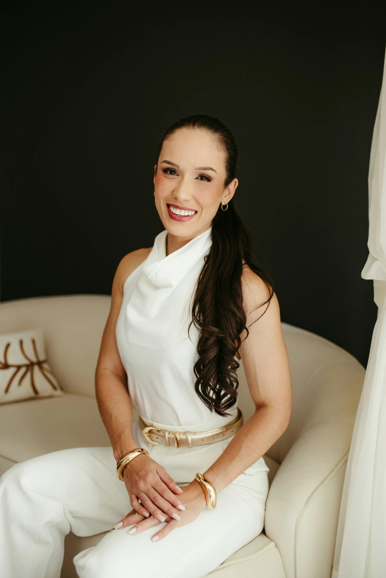 Elena Marlow smiling, seated in the studio