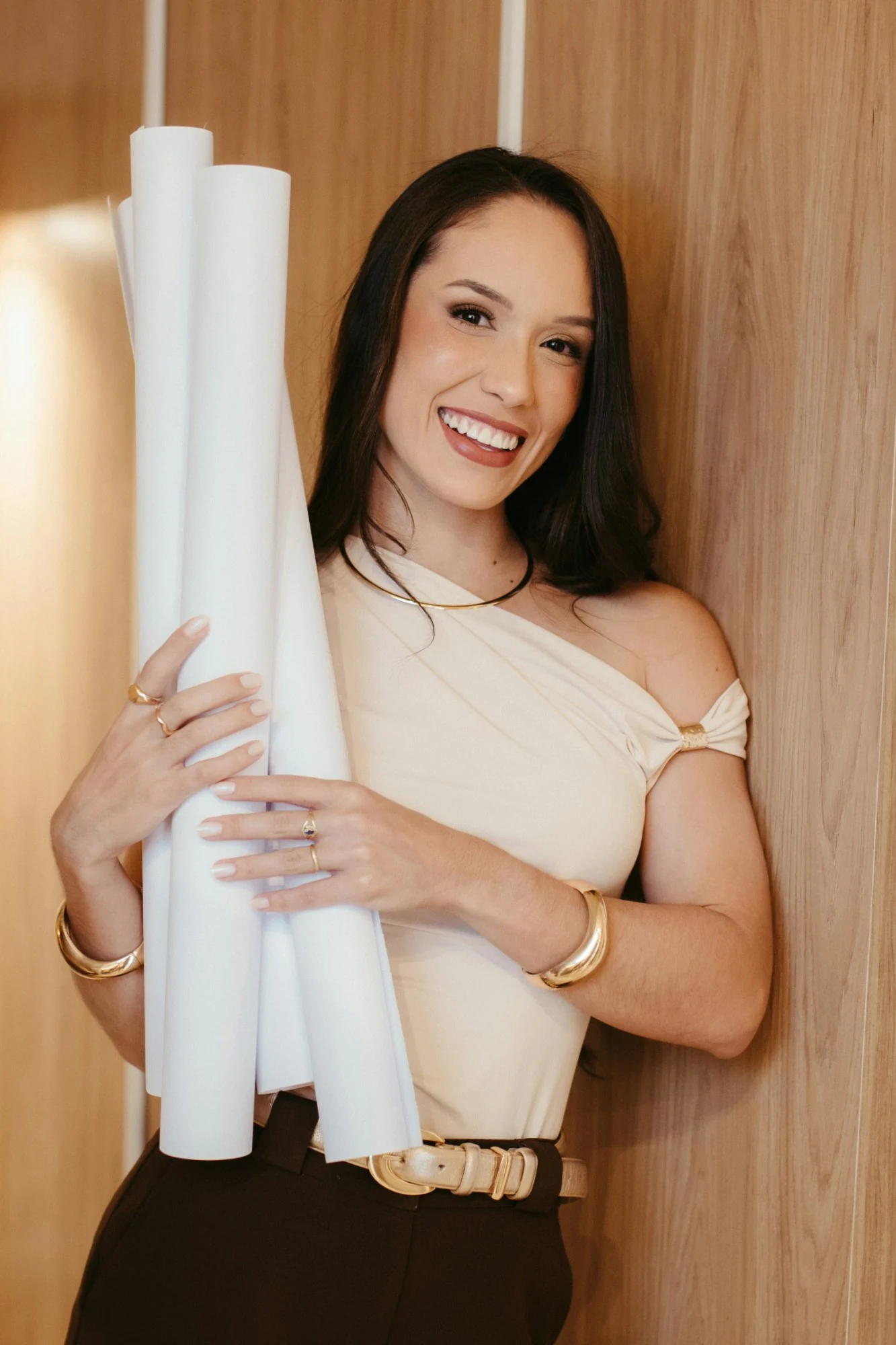 Elena Marlow holding rolled plans, smiling